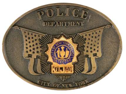 Lot 750 - Kojak belt buckle crew gift from collection of first AD Wolfgang Glattes.