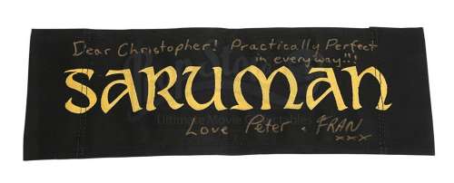 THE LORD OF THE RINGS (2001-2003) - Lot 512 - Sir Christopher Lee Estate Collection: Saruman‘s (Christopher Lee) Chair Back Autographed by Peter Jackson