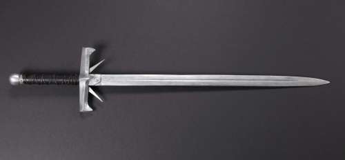 Lot 744 - Clancy Brown hero “Kurgan” sword and two pieces of Kurgan armor from Highlander