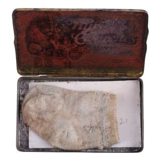 BLADE RUNNER 2049 (2017) - Lot #70 : Sapper Morton‘s (Dave Bautista) Screen-Matched Cigarette Tin with Old Baby Sock and Proxy Photos and VFX Photo