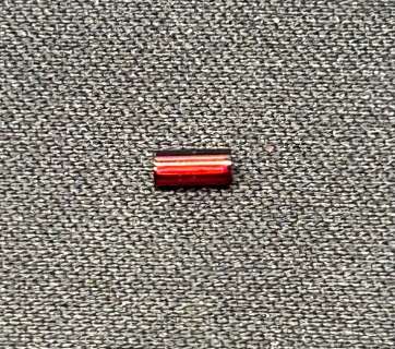 An actual red bugle bead off of an original pair of ruby red slippers from The Wizard of Oz | Piece of the Past