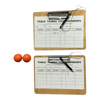Lot 100: Marty Supreme Marty Mauser Production Used (2) British Open Match Cards W/ Clipboards & (2) Marty Supreme Ping Pong Balls | VIP Fan Auctions
