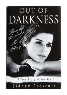 Lot 1267 - SCREAM 4: NEVE CAMPBELL SIGNED "OUT OF DARKNESS" BOOK PROP (WITH DVD)