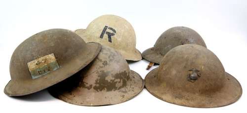 Six Brodie style tin combat helmets from various productions. | Ewbank’s