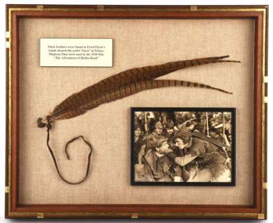 Erroll Flynn - Robin Hood display, containing the original feather from Erroll Flynn’s hat believed… | Ewbank’s