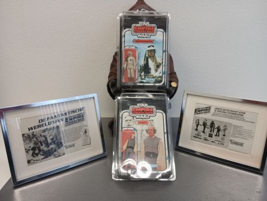 Star Wars Episode V: The Empire Strikes Back - Kenner - Rebel Commander & Lobot (mint) in special protective case - 2 Advertisement newspaper ’80 | Catawiki