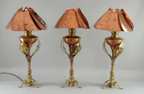 The Golden Compass - Three copper and brass Benson style table lamps from the Gyptian ship, | Ewbank’s