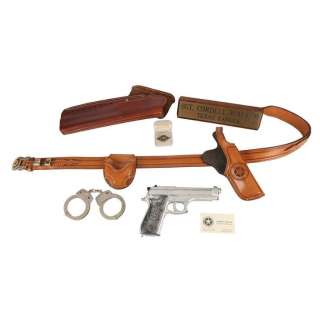 WALKER, TEXAS RANGER (1993-2001) - Lot 1738 - Cordell Walker‘s (Chuck Norris) Stunt Gun, Signet Ring, Handcuffs, Gun Belt, Desk Plaque and Business Card