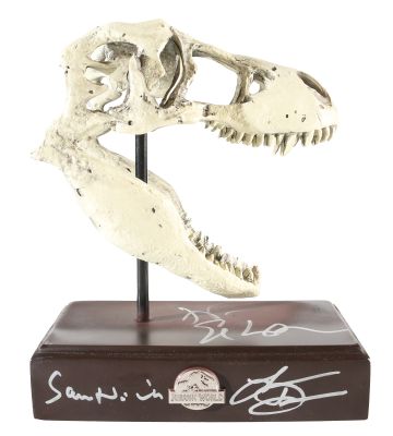 Sam Neill as Alan Grant, Laura Dern as Ellie Sattler, & Jeff Goldblum as Ian Malcolm in Jurassic Park Signed T-Rex Skull Prop Replica Paper Weight | SWAU