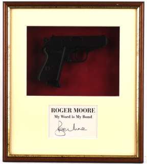 James Bond - A Replica Walther PPK. Mounted inside a framed display with a card signed by Roger… | Ewbank’s