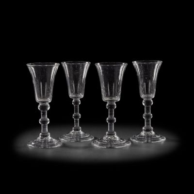 Lot 156 - A set of four matched clear glass dessert glasses, in the 18th century style Made by The Glassmakers in the ’Wedding Scene’ design, from Season 1 onwards (4) | Bonhams