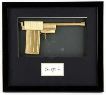 James Bond The Man With The Golden Gun (1974) - A replica golden gun, mounted inside a framed… | Ewbank’s