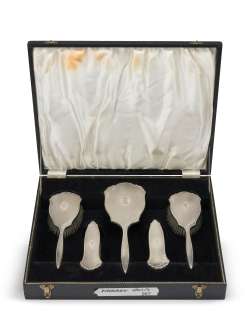 The Crown - Lot 428 - Vanessa Kirby, Helena Bonham Carter & Lesley Manville (as Princess Margaret): A cased and matched silver-mounted dressing set used across seasons and actors (the mirror: 29cm long (5)