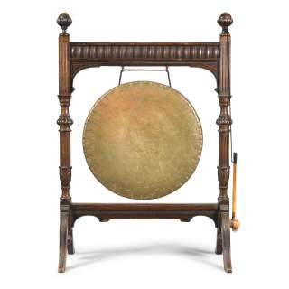 Lot 100 - A large late Victorian oak and brass dinner gong Late 19th / early 20th century, acquired by the Set Decorating Department for the third film, Downton Abbey: The Grand Finale