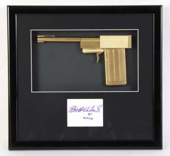 James Bond The Man With The Golden Gun (1974) - A replica golden gun, mounted inside a framed… | Ewbank’s