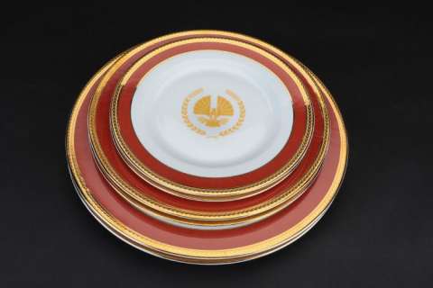 Lot 101 - "President Snow" Panem branded (2) 5-piece dinnerware sets from The Hunger Games: Mockingjay - Part 1.