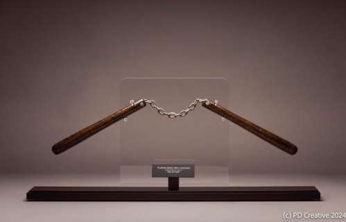 Lot 15 - Bruce Lee | Screen-Used "Fist of Fury" Nunchaku with Photo 李小龍 | 《精武門》電影道具雙節棍連劇照