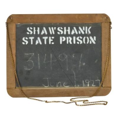 THE SHAWSHANK REDEMPTION (1994) - Lot #322 : Planet Hollywood Collection: Ellis Boyd "Red" Redding‘s (Morgan Freeman) Screen- and Photo-Matched Shawshank State Prison Mugshot Slate with Laundry Leonard‘s (Cornell Wallace) Hand-Marked Prisoner