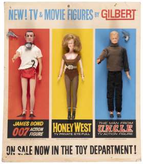 JAMES BOND, HONEY WEST AND MAN FROM U.N.C.L.E. (ILLYA) GILBERT DEPARTMENT TOY EASEL BACK DISPLAY. | Hake’s