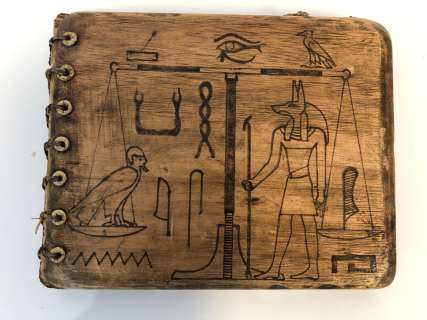 Lot 293 - "Motherland: Fort Salem" - Egyptian motif wooden parchment book w/ hieroglyphics pages
