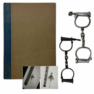 Lot 90: The Light Between Oceans Production Used Log Book, (2) Prop Handcuffs & (2) Police Photos Of Rattle W/ Ruler | VIP Fan Auctions