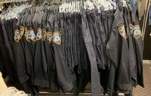 "Superheroes Show" - Rack full of Police Department Liberty Justice uniform shirts/ pants & extra be | Direct Liquidation