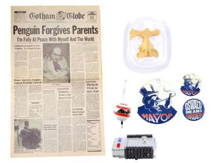 BATMAN RETURNS (1992) - Lot 40 - Oswald Cobblepot‘s (Danny DeVito) Remote Control Device, Campaign Buttons, Face Appliance, and Newspaper