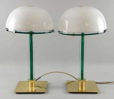 Lot 835 - The Golden Compass - Pair of brass and green column table lamps with brass edged dome shades from…